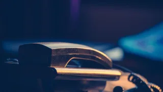 Telefon stacjonarny na biurku — pierwszy kontakt z serwisem komputerowym